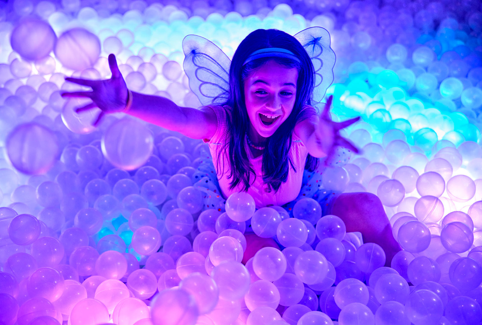 a girl in a ball pit