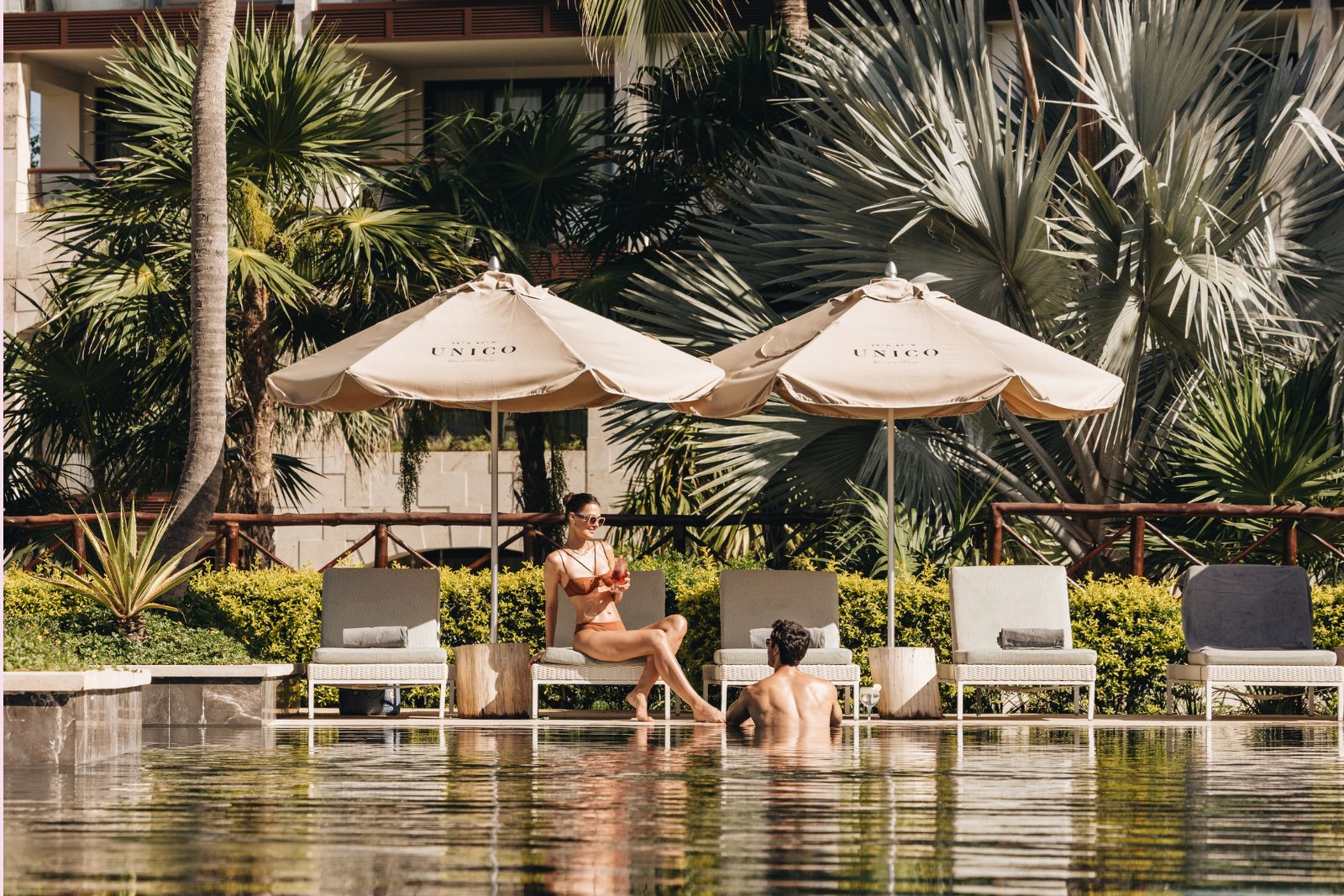 a man and woman sitting in a pool